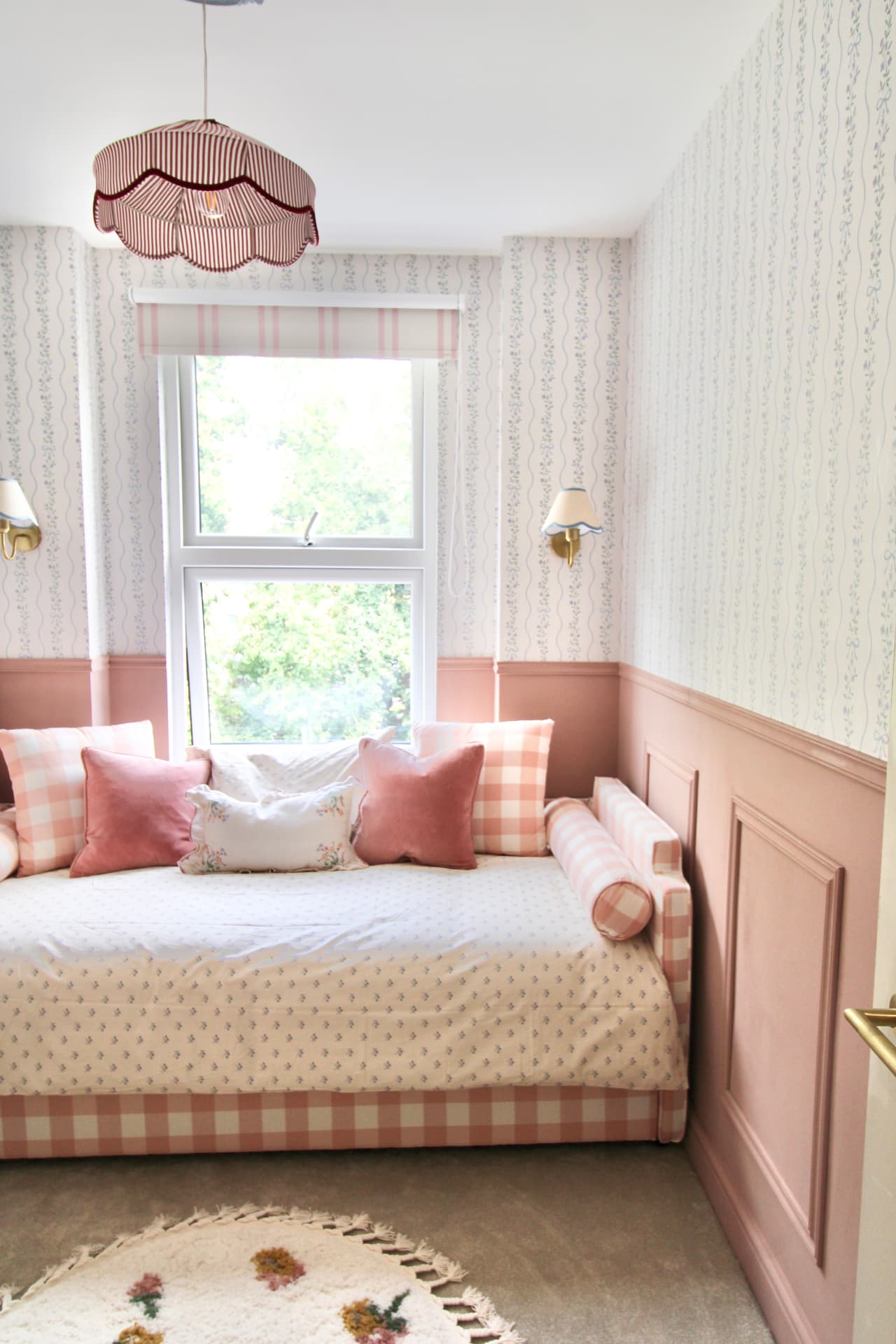 The children's room: gingham daybed, pink panelling and trailing floral wallpaper